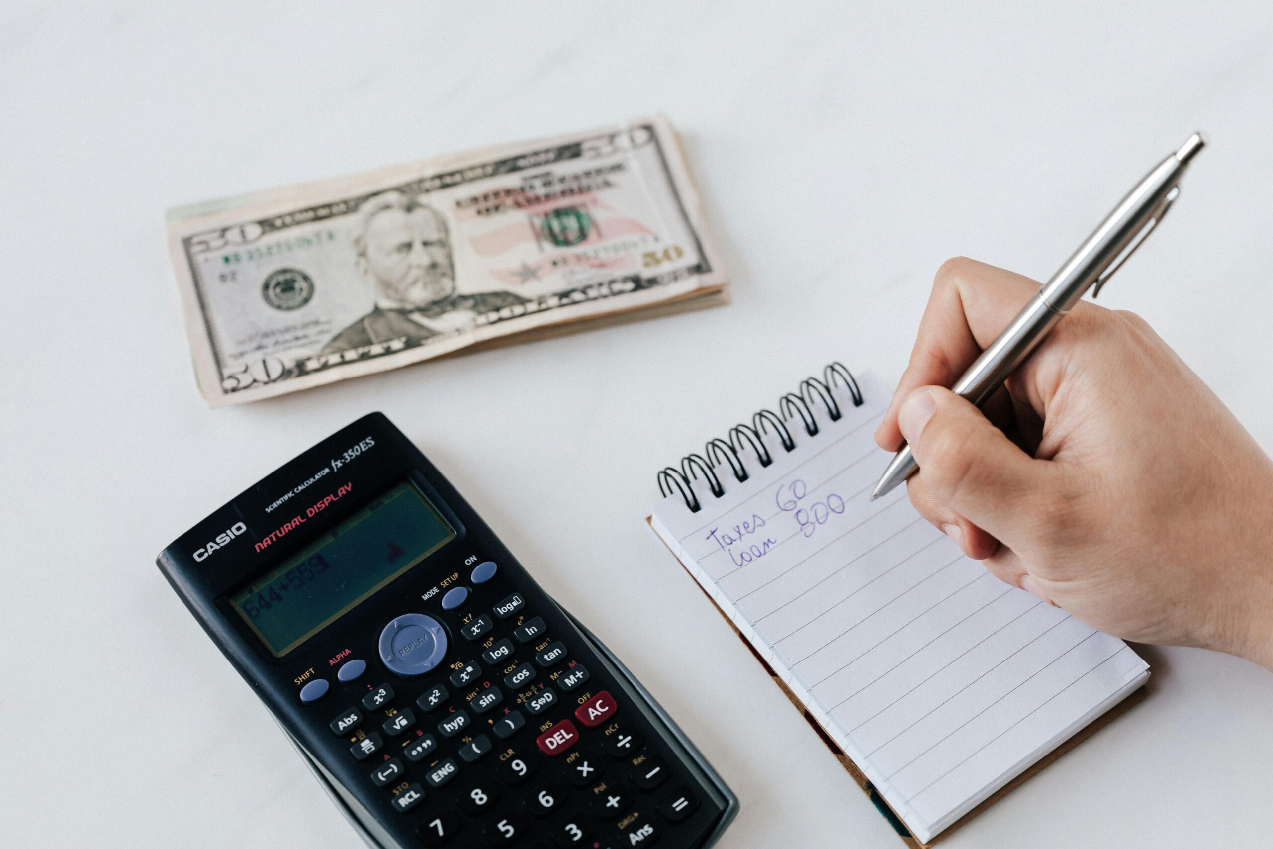 Photo by Photo By: Kaboompics.com: https://www.pexels.com/photo/crop-anonymous-financier-planning-budget-writing-numbers-in-notebook-4386339/